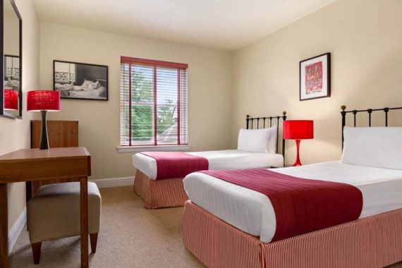 Twin beds in 3 Bedroom Lodge at Duchally Hotel & Country Estate
